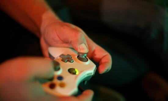 A teenager plays a video game at a trade-show booth during the 'Intel Friday Night Game' organized by the Electronic Sports League at Tonhalle in Munich, Germany, on Nov. 13, 2009, in Munich, Germany. (Miguel Villagran/Getty Images)