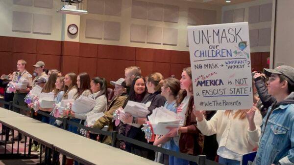Loudoun County Public Schools students suspended for refusing to wear a mask to school present notarized affidavits—one box with 65 copies for each recipient—to the school board members at a board meeting in Ashburn, Va., on Feb. 8, 2022. (Terri Wu/The Epoch Times)
