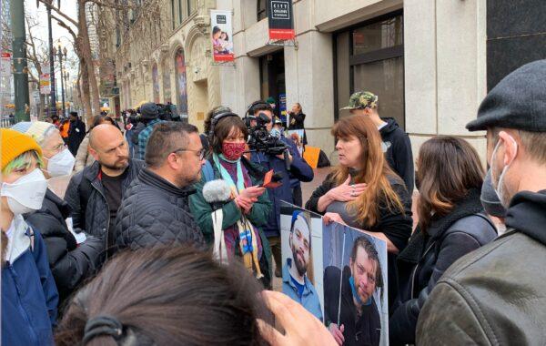 Jacqui Berlinn talks to former city Supervisor David Campos while surrounded by media in front of the Tenderloin Linkage Center in San Francisco on Feb. 5, 2022. (Cynthia Cai/The Epoch Times)