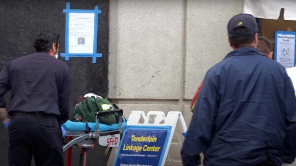 Paramedics respond with a stretcher at the Tenderloin Linkage Center in San Francisco on Feb. 5, 2022. (Cynthia Cai/The Epoch Times)