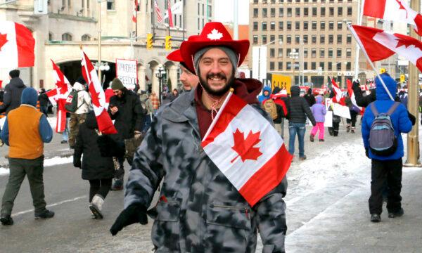 A protester walks on Wellington St. in Ottawa on Feb. 12, 2022. (Noé Chartier/The Epoch Times)