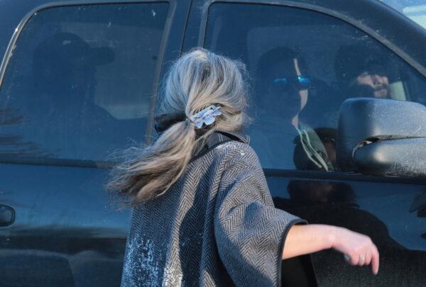 A woman yells at the occupants of a vehicle heading to central Ottawa on Feb. 13, 2022. (Richard Moore/The Epoch Times)