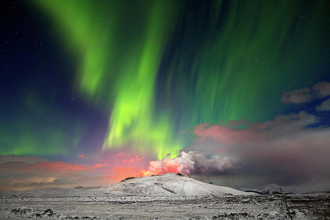 American Expat Photographer Captures Epic Scene of Northern Lights Behind Erupting Volcano in Iceland