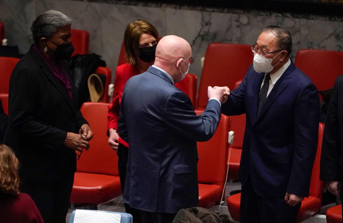 Permanent Representative of the Russian Federation to the United Nations (UN) Vasily Nebenzya (C) fist bumps Ambassador Zhang Jun, Permant Representative of China to the UN, as US ambassador to the UN Linda Thomas-Greenfield (L) and Permanent Representative of Norway to the United Nations Mona Juul (2nd L) look on during an emergency meeting of the UN Security Council on the Ukraine crisis, in New York, N.Y., on Feb. 21, 2022. (Timothy A. Clary/AFP via Getty Images)