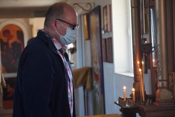 A parishioner in prayer before the Sunday liturgy service at Holy Archangels Orthodox Church in Phoenix, Ariz., on March 6. (Allan Stein/The Epoch Times)