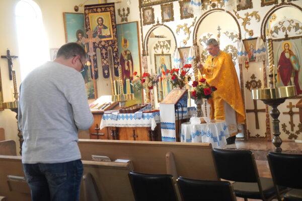 A parishioner bows his head in prayer during a Sunday morning liturgy service at St. Mary's Protectress Ukrainian Orthodox Church in Phoenix, Ariz., on March 6. (Allan Stein/The Epoch Times)