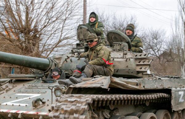 Russian troops in uniforms without insignia are seen atop a tank with the letter "Z" painted on its sides, in the Donetsk region, Ukraine, on March 1, 2022. (Alexander Ermochenko/Reuters)