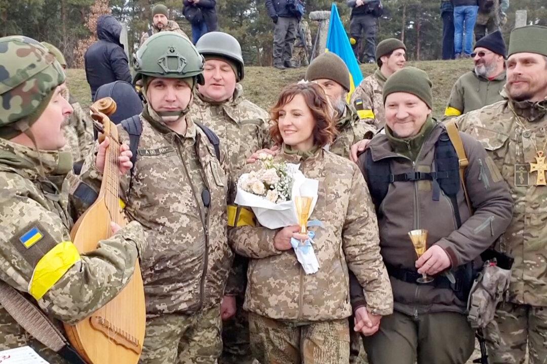 ‘We Must Live in the Moment’: Ukrainian Reservists Marry in Military Fatigues at Kyiv Checkpoint