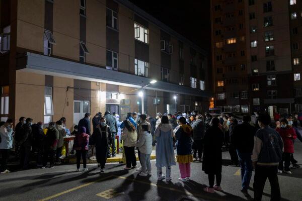 People line up for a throat swab during mass COVID-19 testing in a residential community in Shanghai, on March 10, 2022. China is tackling a COVID-19 spike with selective lockdowns and other measures that appear to slightly ease its draconian zero tolerance strategy. (AP Photo)