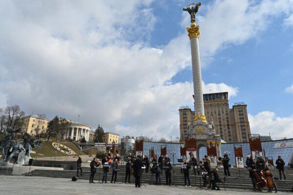 Musicians of the Kyiv-Classic Symphony Orchestra under the direction of conductor UNESCO Peace Artist Herman Makarenko perform at Independence Square in Kyiv, Ukraine, on March 9, 2022, to call NATO to close the skies over Ukraine. (SERGEI SUPINSKY/AFP via Getty Images)