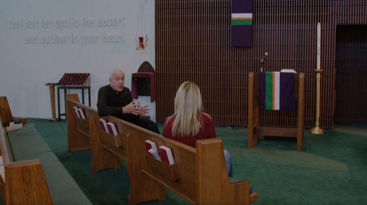 The Priest (Fred Gerle) and Laura (Tina Marie Nigro) have a talk in “Anti Coronavirus.” (Applied Art Productions)