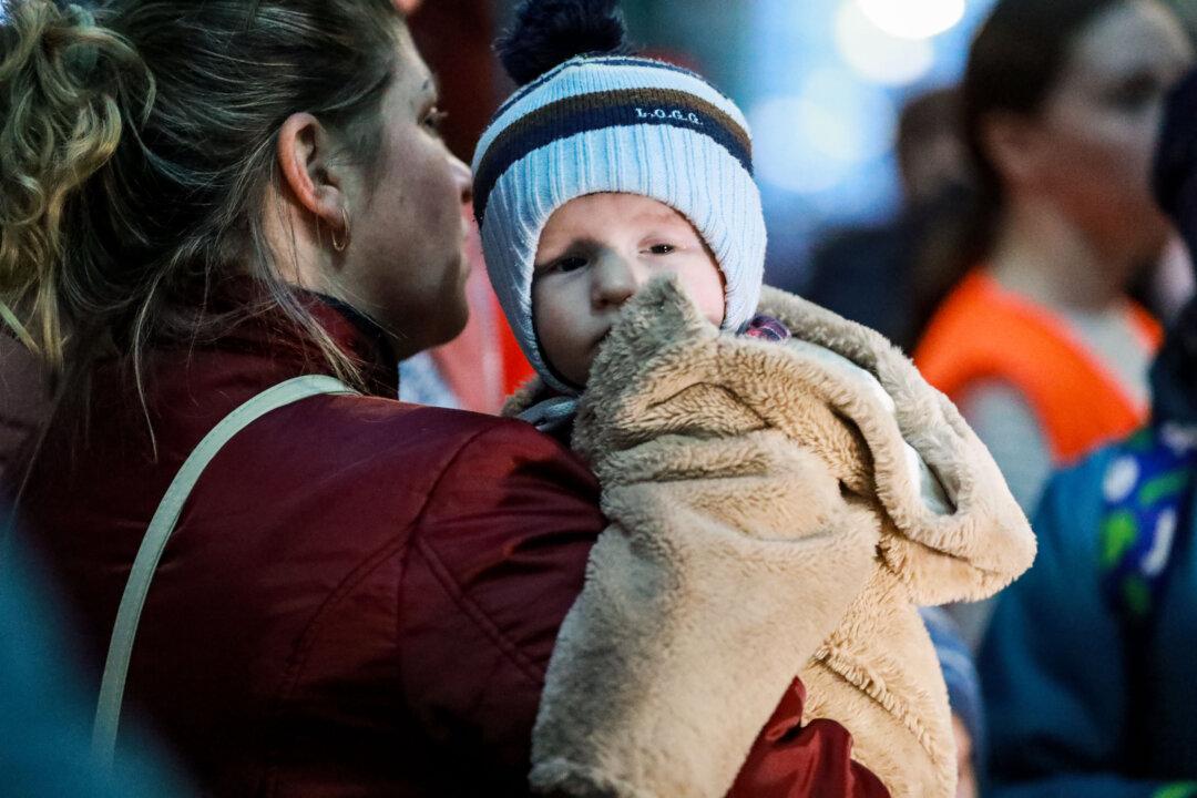At Ukraine Train Station, Some Mothers Wait to Flee, Others Return Home