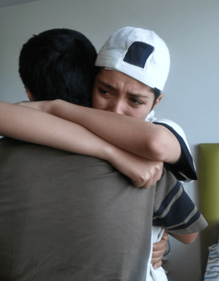 Yaeli Martinez (R) hugs her younger brother on her 17th birthday at the group home in 2017 when her mother surprised her and brought her brother and sisters to visit. (Courtesy of Abigail Martinez)