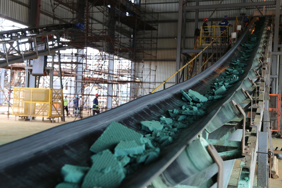 A conveyor belt carries chunks of raw cobalt after the first transformation at a plant in Lubumbashi, DRC, on Feb. 16, 2018, before it is exported, mainly to China, and refined. (Samir Tounsi/AFP via Getty Images)