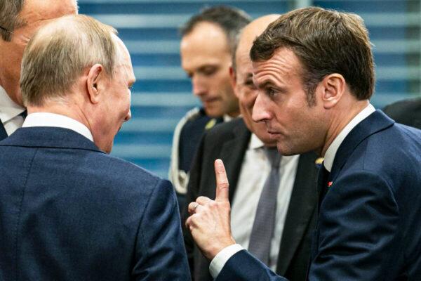 French President Emmanuel Macron (R) speaks with Russian President Vladimir Putin (L) before a meeting at the Chancellery on January 19, 2020 in Berlin, Germany. (Emmanuele Contini/Getty Images)