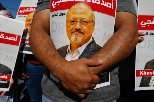 People hold posters of slain Saudi journalist Jamal Khashoggi, near the Saudi Arabia consulate in Istanbul, Turkey, on Oct. 2, 2020. (Emrah Gurel/AP Photo)