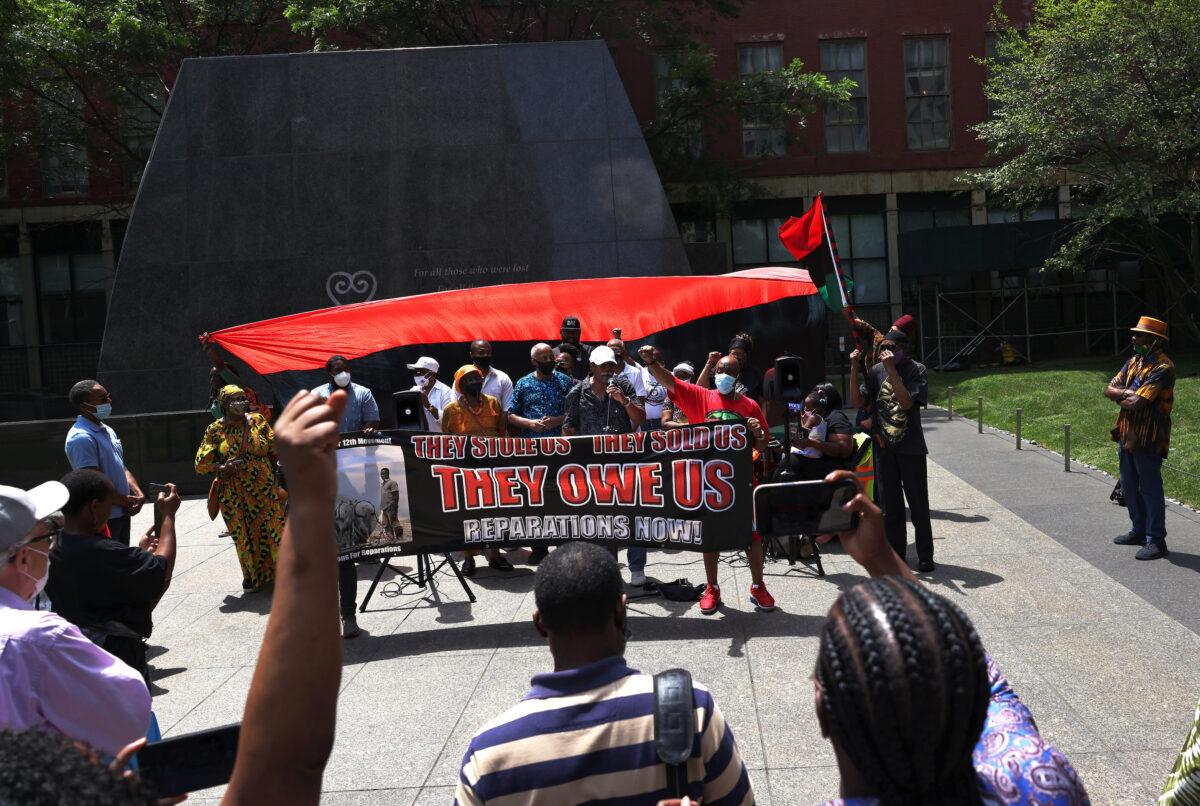 People listen to speakers during a rally for reparations at the African Burial Ground National Monument in New York on July 23, 2021. (Michael M. Santiago/Getty Images)