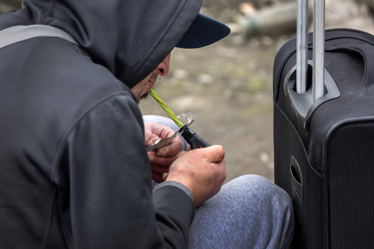 A homeless man, 24, smokes fentanyl in Seattle on March 12, 2022. (John Moore/Getty Images)