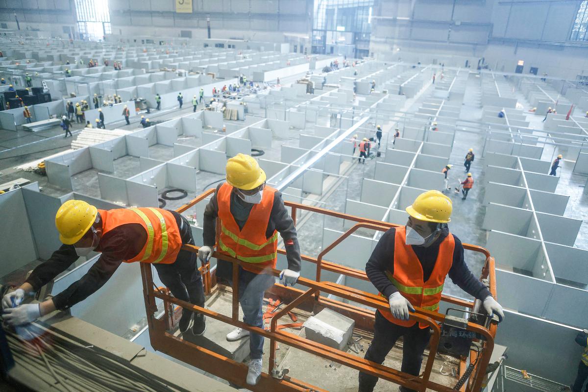 Employees setting up a makeshift hospital on April 7, 2022, that will be used for COVID-19 patients in Shanghai. (CNS/AFP via Getty Images)