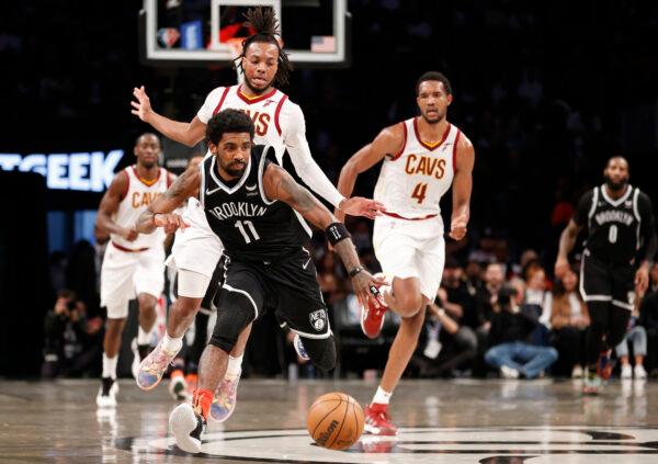 Kyrie Irving #11 of the Brooklyn Nets and Darius Garland #10 of the Cleveland Cavaliers chase a loose ball during the first half of the Eastern Conference 2022 Play-In Tournament at Barclays Center, in the Brooklyn borough of New York, on April 12, 2022. (Sarah Stier/Getty Images)