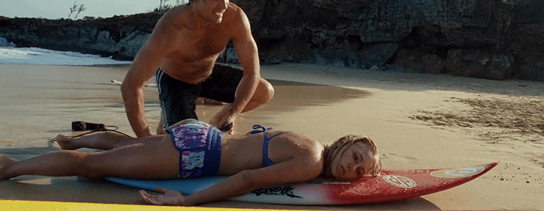 Holt Blanchard (Kevin Sorbo) rescuing Bethany Hamilton (AnnaSophia Robb) after a shark attack, in "Soul Surfer." (Sony Pictures Releasing)