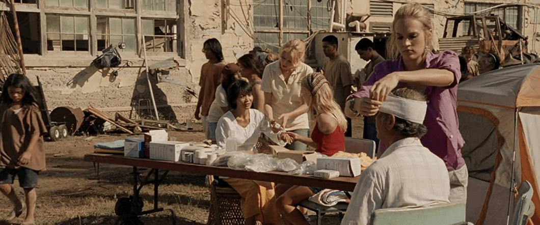 Sarah Hill (Carrie Underwood, standing C) and Bethany Hamilton (AnnaSophia Robb, seated, in red) helping people in need, in "Soul Surfer." (Sony Pictures Releasing)
