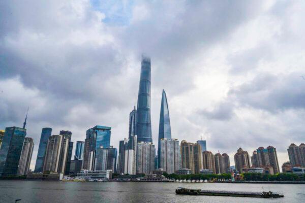 A boat travels on the Huangpu River as the skyline of the city is seen, including the Shanghai Tower, in Shanghai, China, on Aug. 28, 2020. (Kevin Frayer/Getty Images)