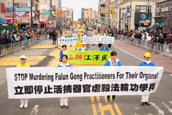 Falun Gong practitioners participate in a parade to commemorate the 23rd anniversary of the April 25th peaceful appeal of 10,000 Falun Gong practitioners in Beijing, in Flushing, N.Y., on April 23, 2022. (Larry Dye/The Epoch Times)