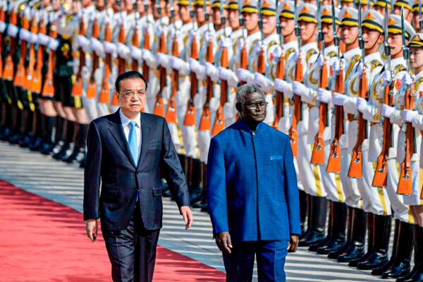 Solomon Islands Prime Minister Manasseh Sogavare and Chinese Premier Li Keqiang inspect honor guards during a welcome ceremony at the Great Hall of the People in Beijing on Oct. 9, 2019. (Wang Zhao/AFP via Getty Images)