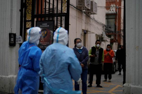 Residents line up for nucleic acid tests during a lockdown in Shanghai on April 16, 2022. (Aly Song/Reuters)
