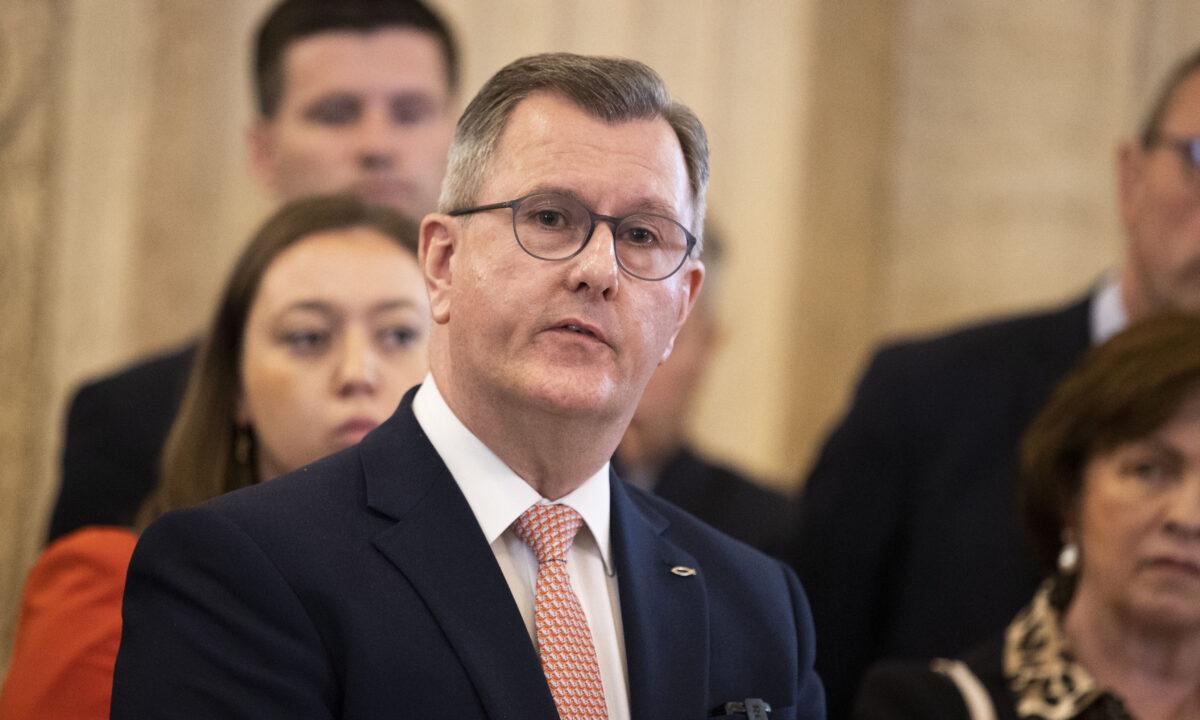 DUP leader Sir Jeffrey Donaldson with party colleagues, speaking at the podium in the Great Hall of Parliament Buildings at Stormont in Belfast, Northern Ireland, on May 13, 2022. (Liam McBurney/PA Media)