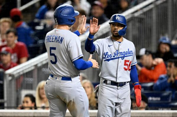Mookie Betts #50 and Freddie Freeman #5 of the Los Angeles Dodgers celebrate after scoring in the sixth inning against the Washington Nationals at Nationals Parkin Washington DC, on May 23, 2022. (Greg Fiume/Getty Images)