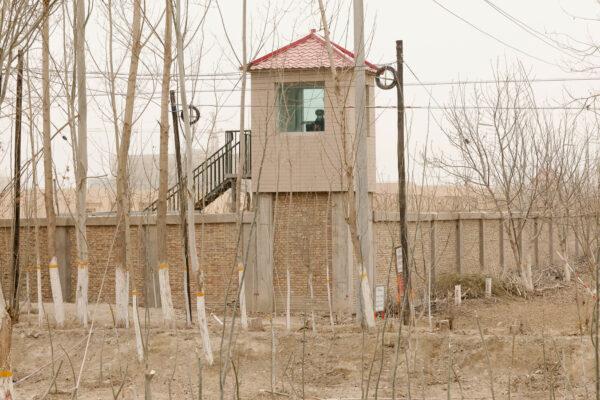 A security person watches from a guard tower around a detention facility in Yarkent County in northwestern China's Xinjiang Uyghur Autonomous Region, on March 21, 2021. (AP Photo/Ng Han Guan, File)