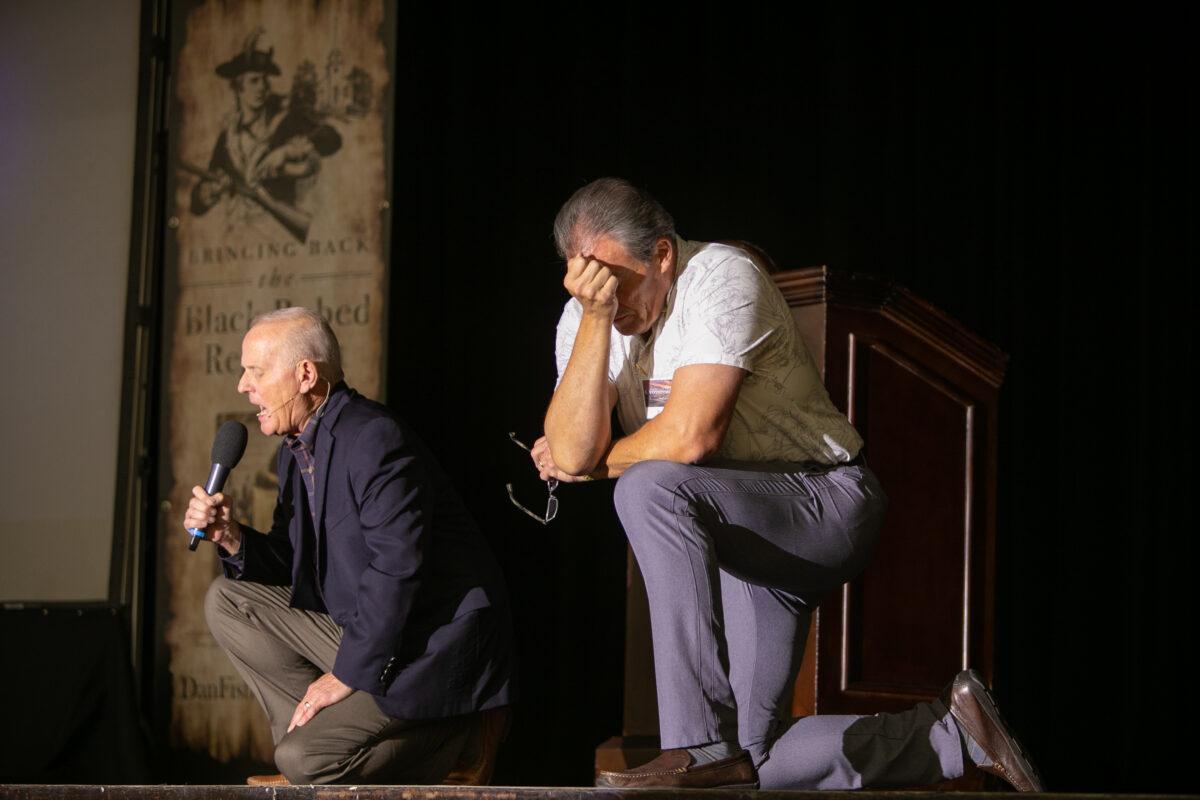 Liberty Pastors founder Paul Blair (R) kneels in prayer while encouraging patriotism within Christian churches during a conference in Grapevine, Texas on Aug. 30, 2020. (Courtesy of Liberty Pastors)