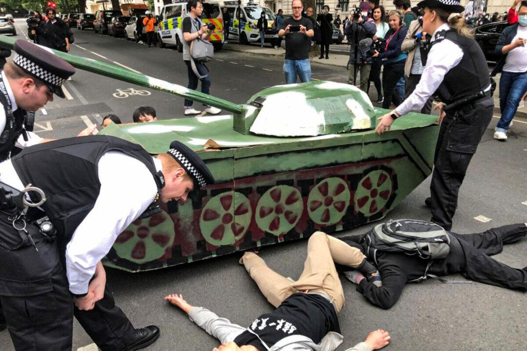 British Police Stand in Way of Tank Symbolising Tiananmen Square Protests