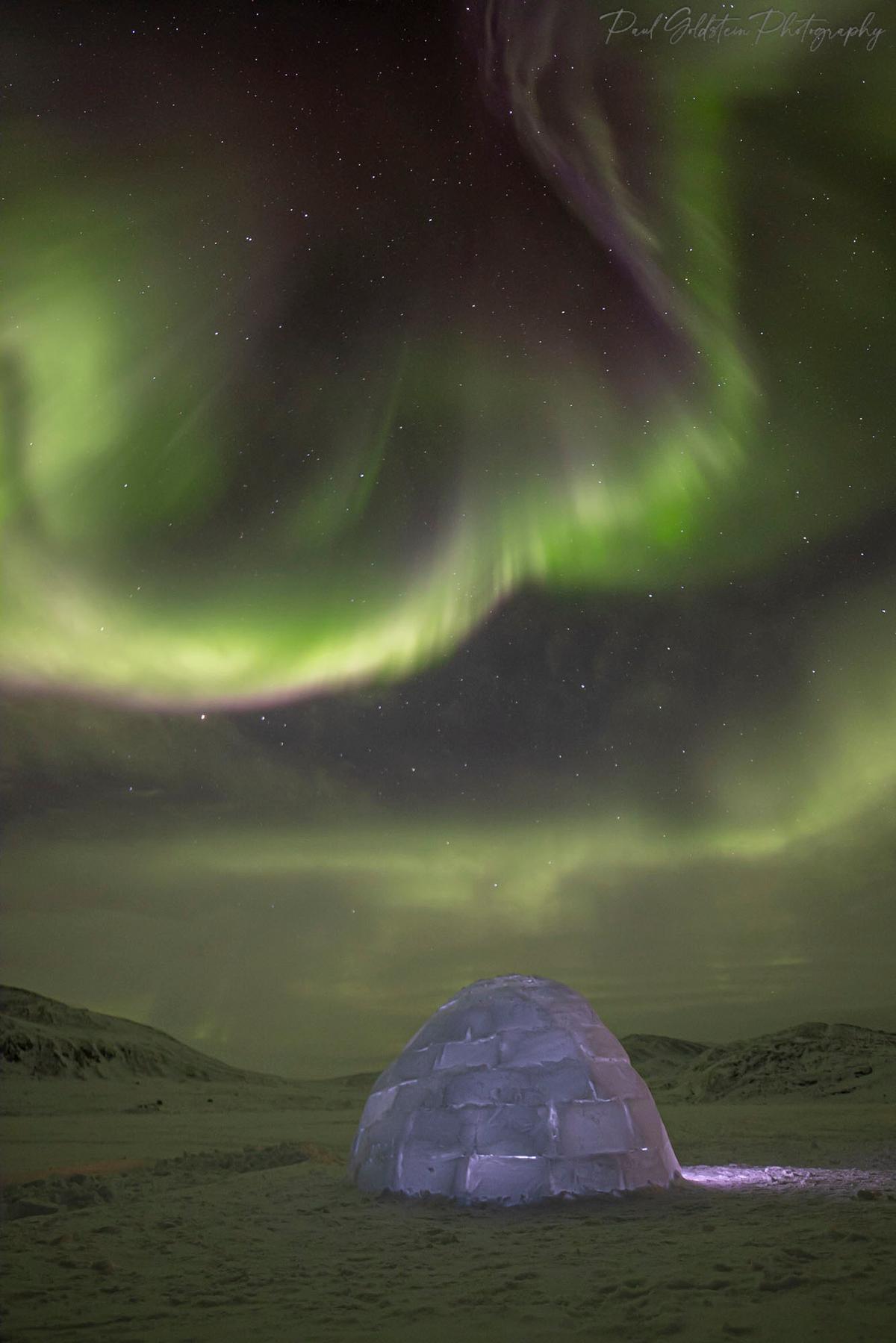 Northern lights dancing above an igloo in Nunavut, Canada. (Courtesy of <a href="https://www.instagram.com/paulsgoldstein/">Paul Goldstein</a>)