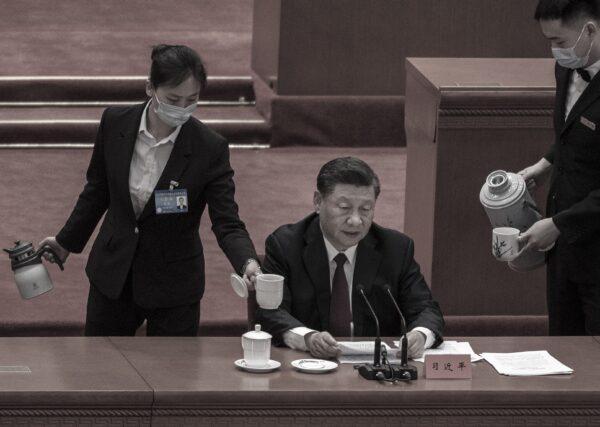 Chinese leader Xi Jinping is served tea as he speaks during a ceremony at the Great Hall of the People in Beijing on April 8, 2022. (Kevin Frayer/Getty Images)
