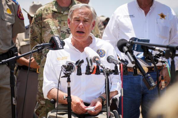Texas Gov. Greg Abbott, flanked by state and local law enforcement officials, speaks to media in Eagle Pass, Texas, on June 29, 2022. (Charlotte Cuthbertson/The Epoch Times)