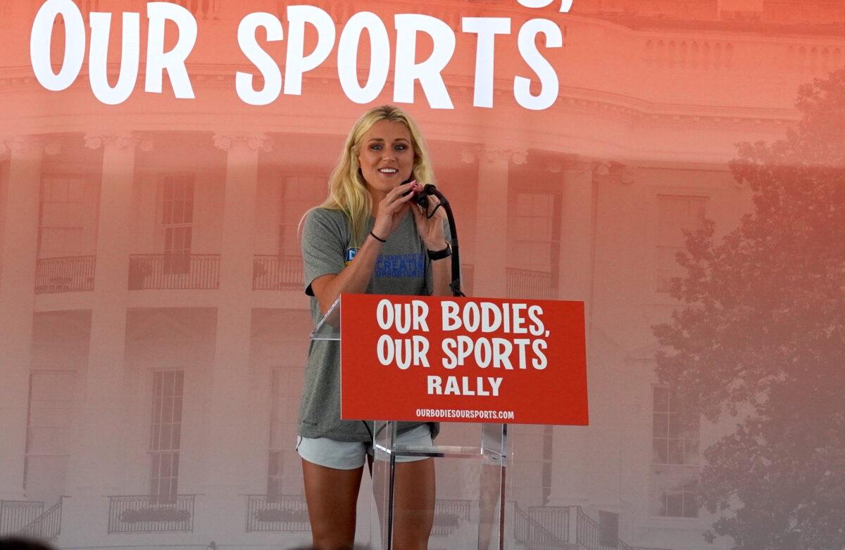 Riley Gaines Barker, a former University of Kentucky swimmer who tied for fifth place against transgender swimmer Lia Thomas at the NCAA Championships in March, speaks at the “Our Bodies, Our Sports” rally at Freedom Plaza in Washington on June 23, 2022. (Terri Wu/The Epoch Times)