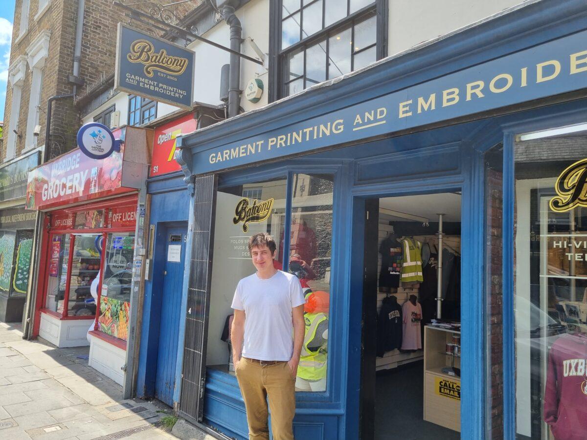 Scott Balcony stands outside his t-shirt shop in Uxbridge, on July 7, 2022. (Chris Summers/The Epoch Times)
