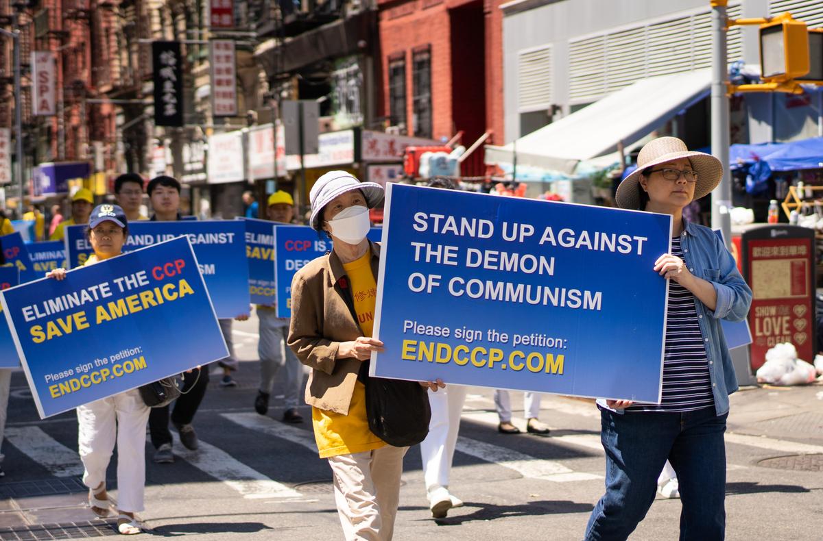 Falun Gong practitioners take part in a parade to commemorate the 23rd anniversary of the persecution of the spiritual discipline in China, in New York's Chinatown on July 10, 2022. (Samira Bouaou/The Epoch Times)