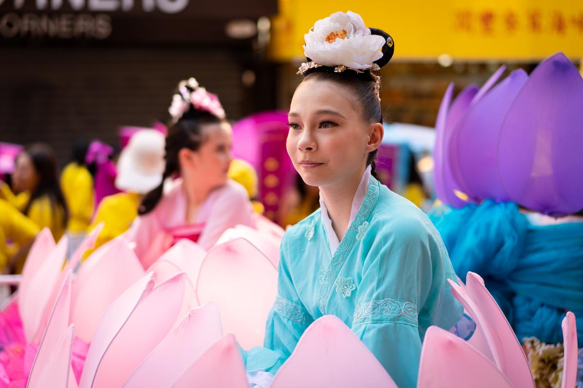 Falun Gong practitioners take part in a parade to commemorate the 23rd anniversary of the persecution of the spiritual discipline in China, in New York's Chinatown on July 10, 2022. (Samira Bouaou/The Epoch Times)