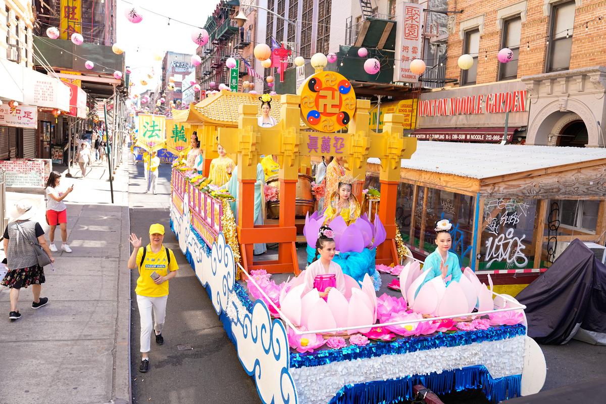 Falun Gong practitioners take part in a parade to commemorate the 23rd anniversary of the persecution of the spiritual discipline in China, in New York's Chinatown on July 10, 2022. (Larry Dye/The Epoch Times)