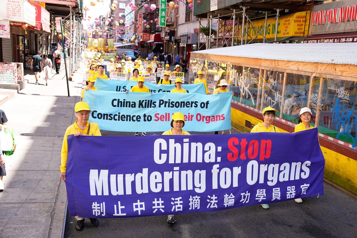 Falun Gong practitioners take part in a parade to commemorate the 23rd anniversary of the persecution of the spiritual discipline in China, in New York's Chinatown on July 10, 2022. (Larry Dye/The Epoch Times)