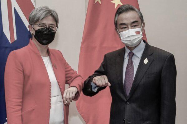 Australia's Foreign Minister Penny Wong (L) bumps elbows with China's Foreign Minister Wang Yi during their bilateral meeting on the sidelines of G20 Foreign Ministers Meeting in Nusa Dua on Indonesia's resort island of Bali on July 8, 2022. (Johannes P. Christo/Pool/AFP via Getty Images)