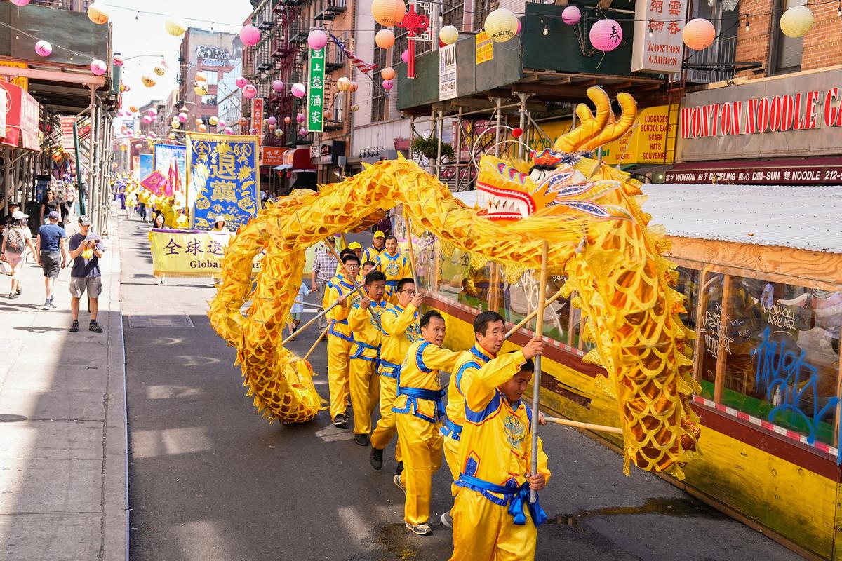 Falun Gong practitioners take part in a parade to commemorate the 23rd anniversary of the persecution of the spiritual discipline in China, in New York's Chinatown on July 10, 2022. (Larry Dye/The Epoch Times)
