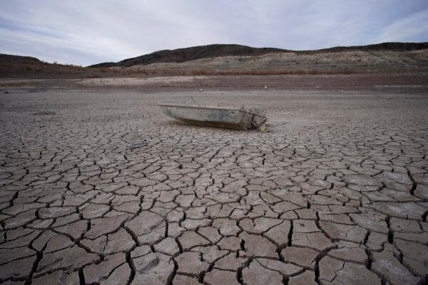 A formerly sunken boat sits on cracked earth hundreds of feet from the shoreline at the Lake Mead National Recreation Area on May 10, 2022, near Boulder City, Nev. (John Locher/AP)