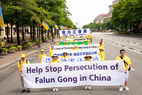 Falun Gong practitioners march down Pennsylvania Avenue to commemorate the 23rd anniversary of the Chinese Communist Party's persecution of the spiritual practice in China, in Washington on July 21, 2022. (Larry Dye/ The Epoch Times)