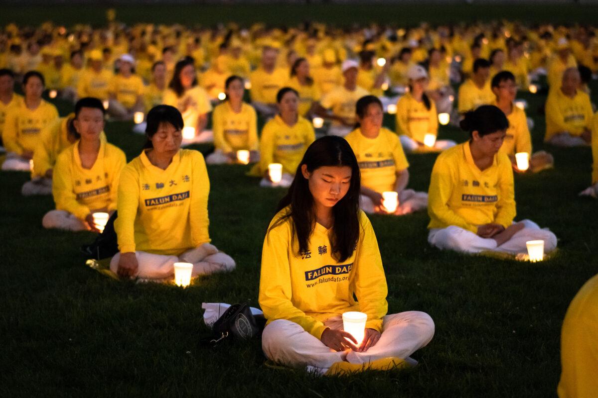 Over 1,000 Falun Gong practitioners hold a candlelight vigil at the Washington Monument on July 21, 2022. (Samira Bouaou/The Epoch Times)
