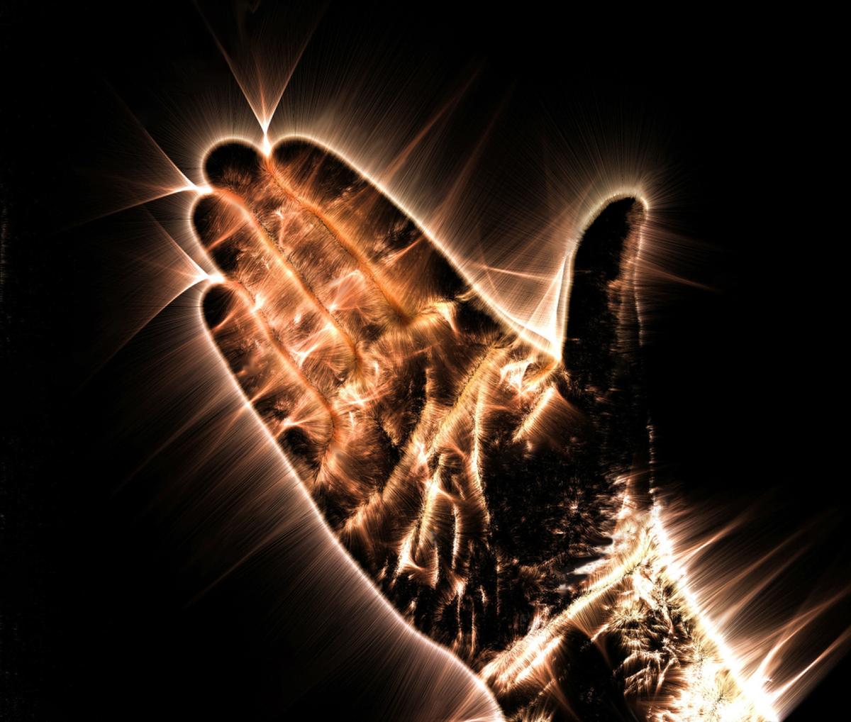 Kirlian aura photography shows a glowing human hand. (MP_Foto/Shutterstock)